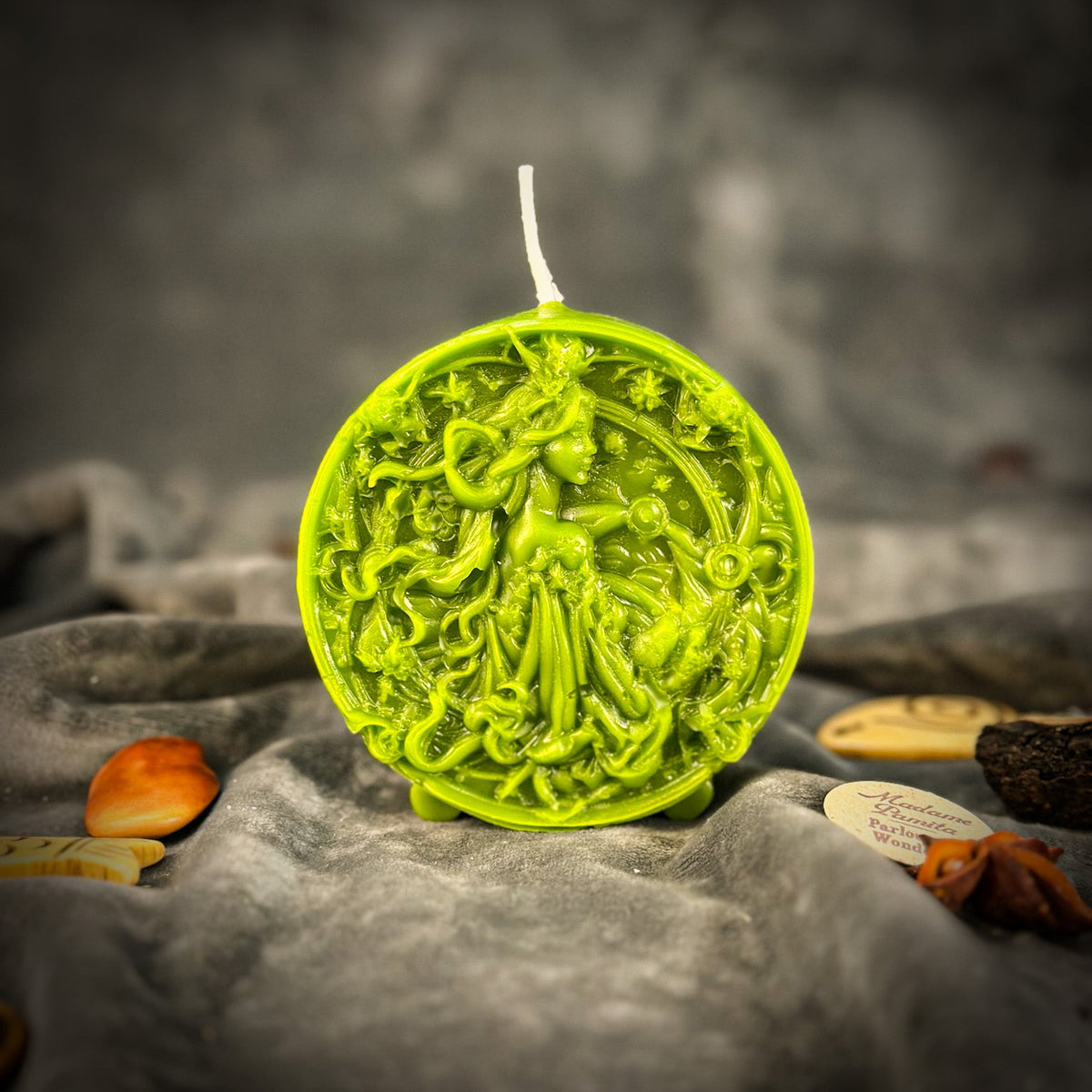 Libra Scales zodiac spell candle in green on draped gray fabric