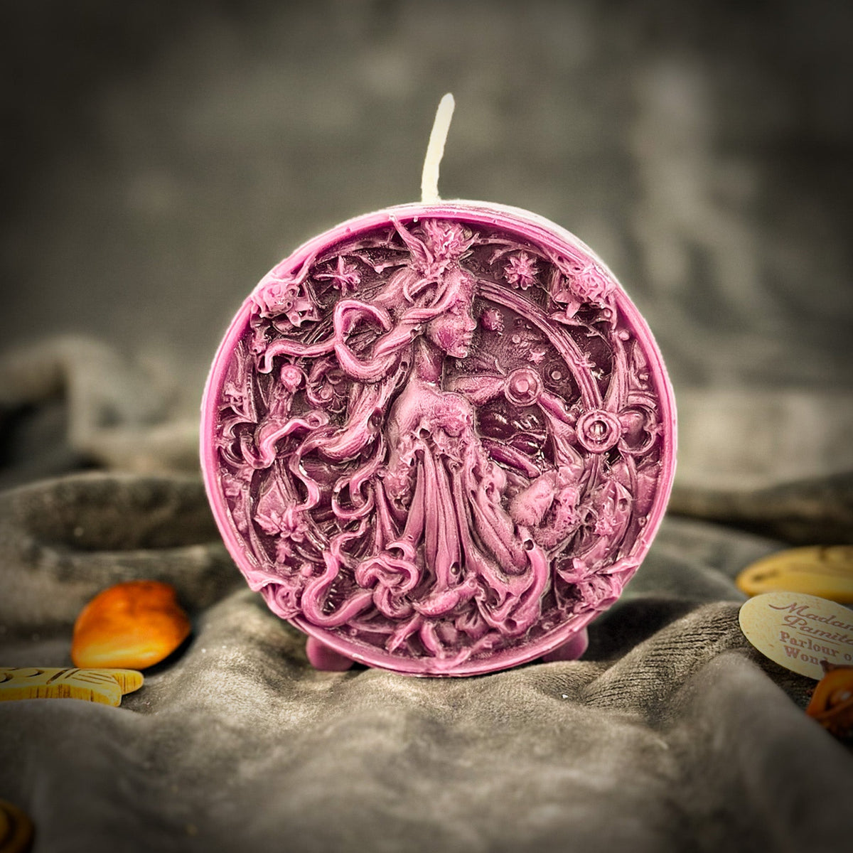 Libra Scales zodiac spell candle in purple on draped gray fabric