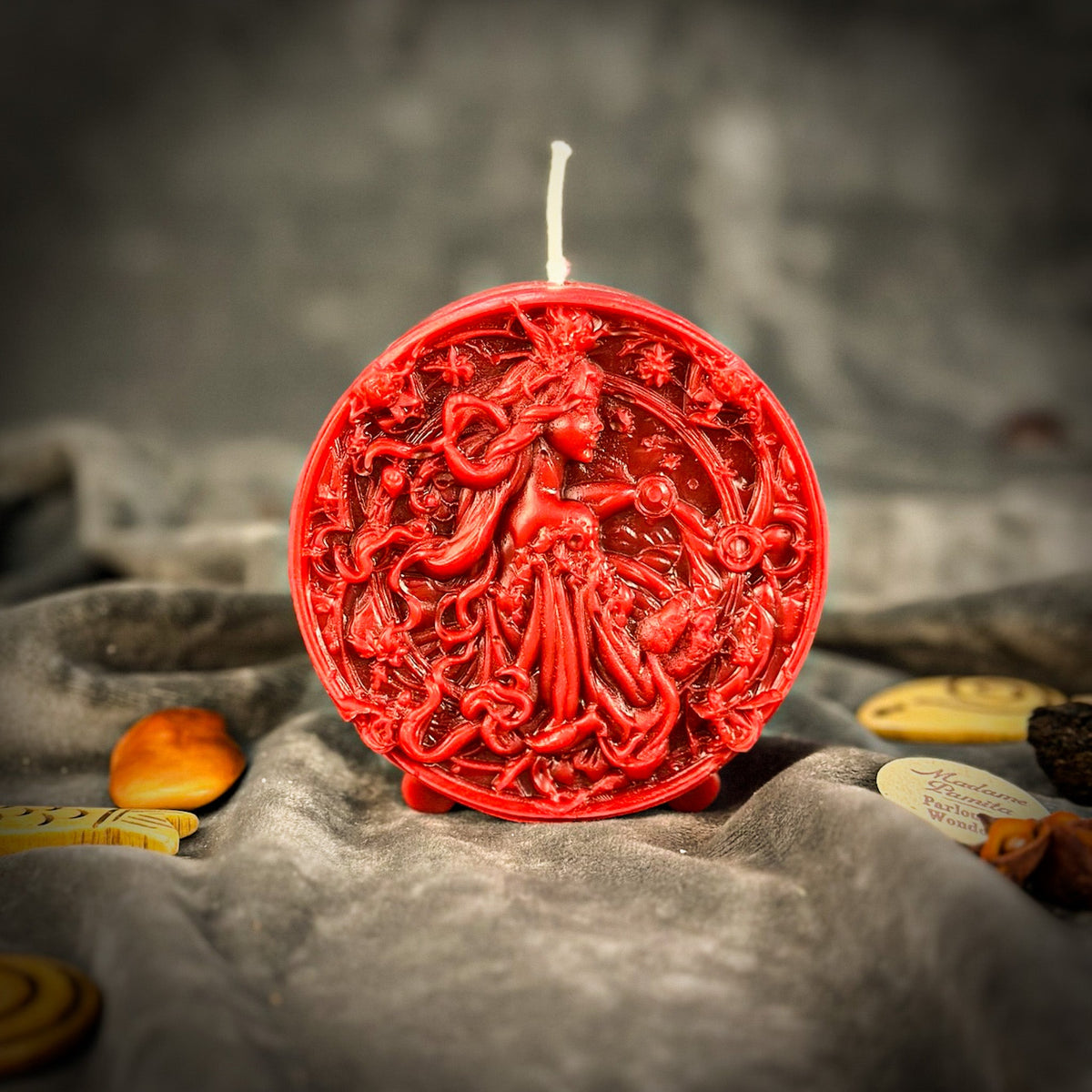 Libra Scales zodiac spell candle in red on draped gray fabric