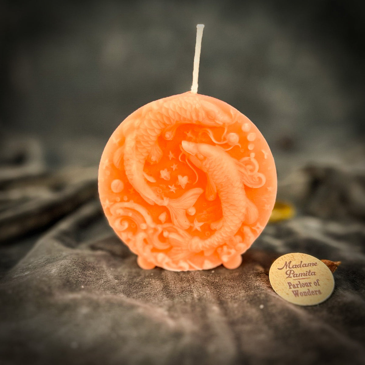 Peach Pisces medallion candle, the palest of the warm colors.