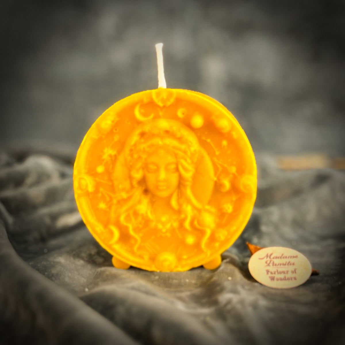 Amber-yellow Virgo medallion candle, the most translucent of the range.