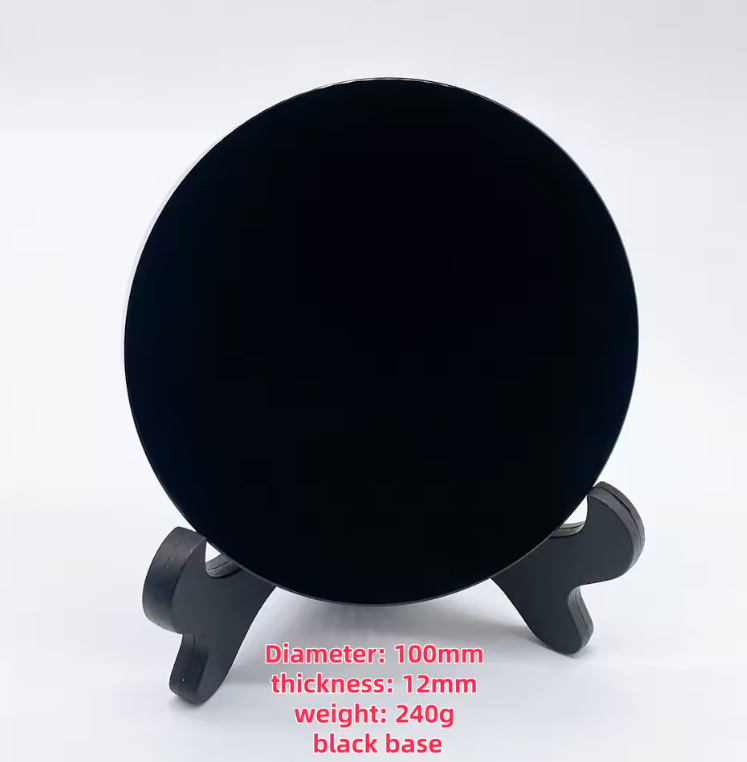 Round polished black obsidian scrying mirror resting on its base stand — view 10 of 11