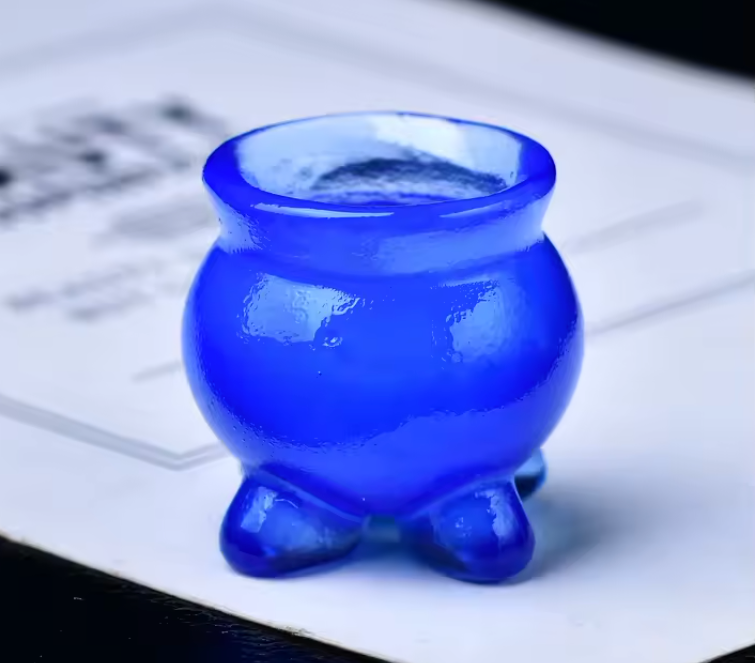 Small carved crystal cauldron with two handles, shown as an altar piece and crystal sphere stand — product photo 4