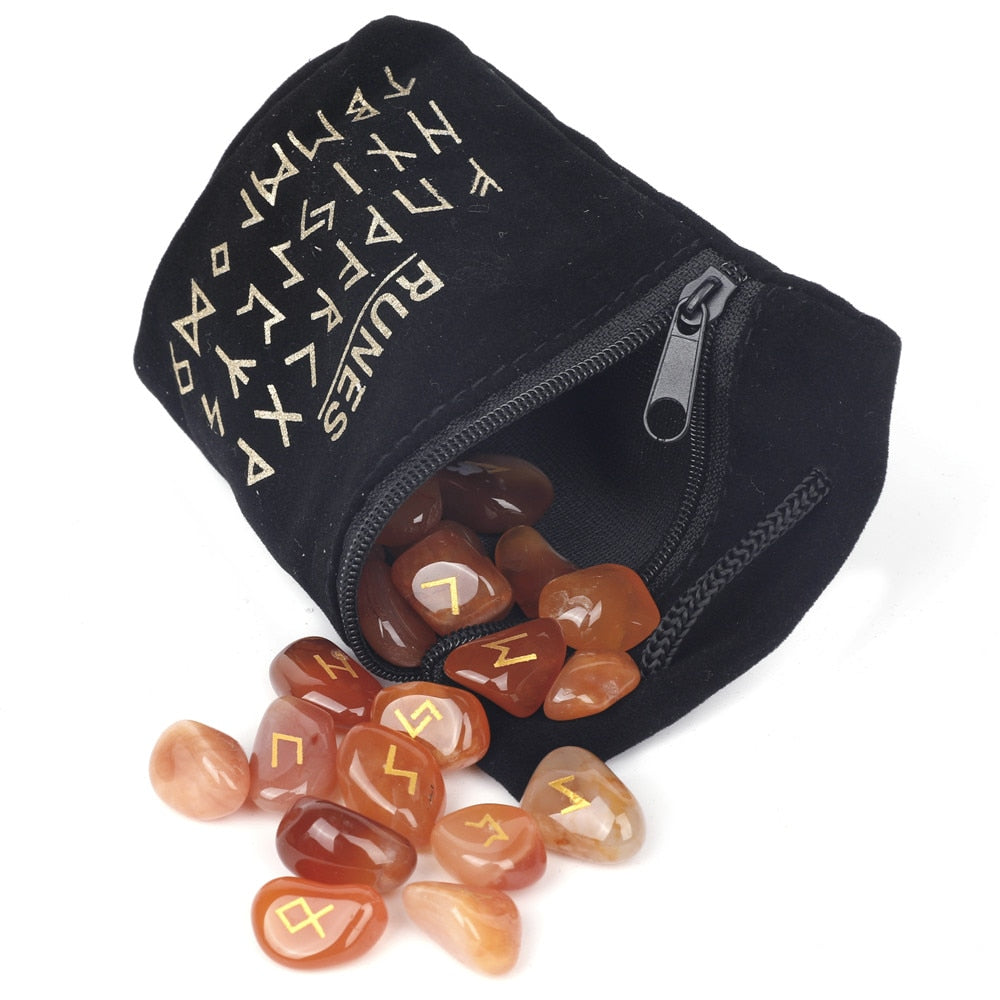 Set of twenty-five carved crystal runes laid out beside a velvet drawstring storage bag — product photo 2