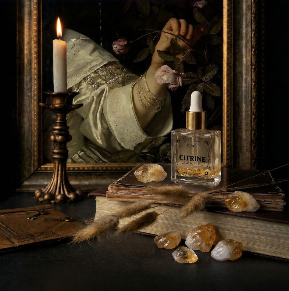 Citrine gemstone shimmer body oil in an apothecary glass bottle with citrine crystals (view 4)
