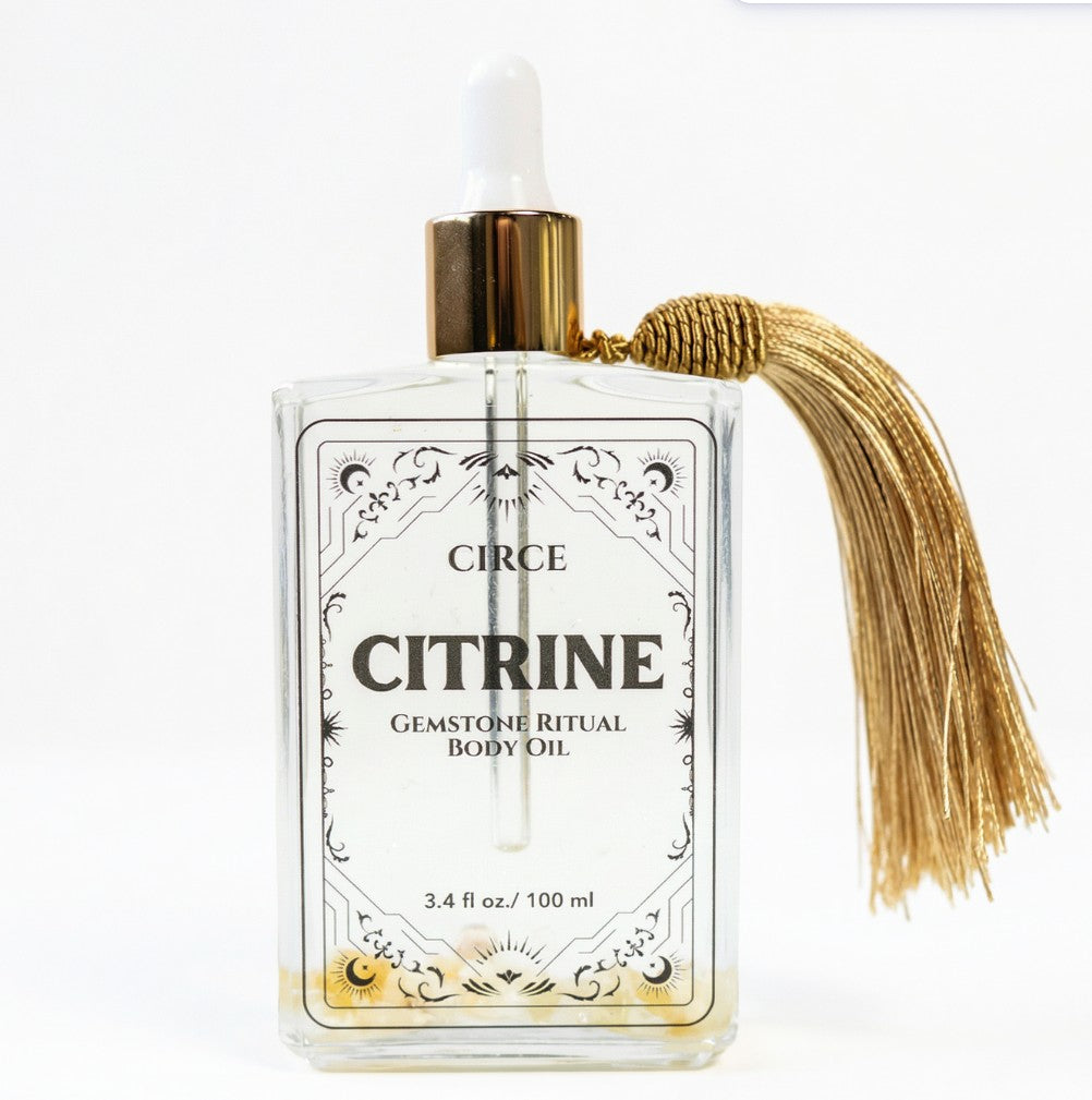 Citrine gemstone shimmer body oil in an apothecary glass bottle with citrine crystals (view 6)