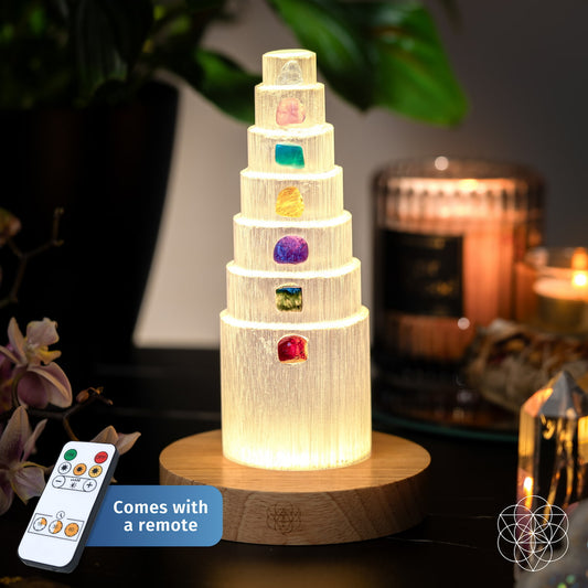Crystal lamp with seven different colored stones glowing on a wooden base