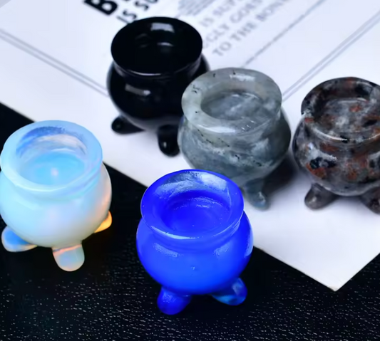 Small carved crystal cauldron with two handles, shown as an altar piece and crystal sphere stand