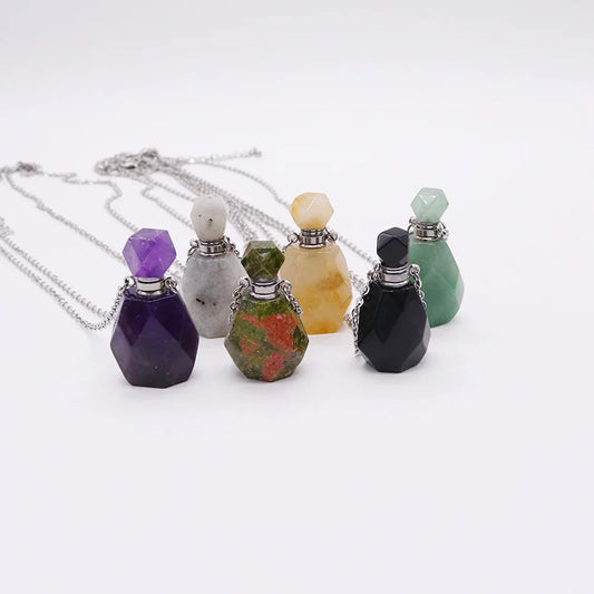Small glass potion bottle pendant filled with crystals on a stainless steel chain — view 1 of 12
