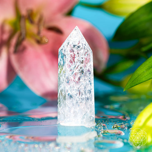Ice Quartz crystal point with fractured internal prisms catching the light