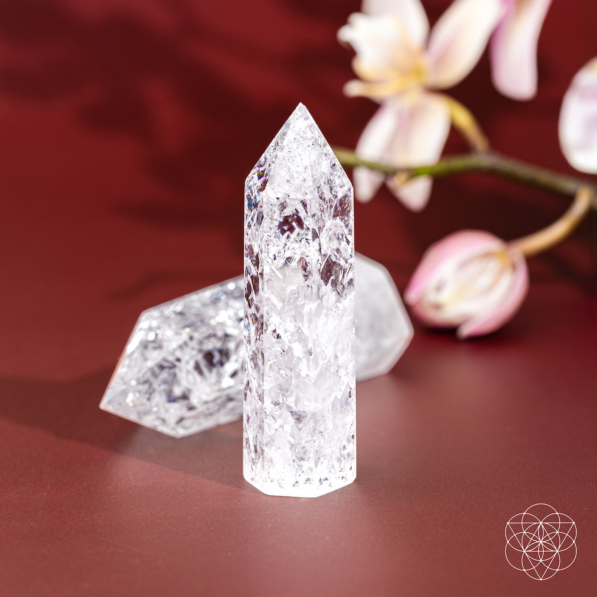 Ice Quartz crystal point with fractured internal prisms catching the light — view 6