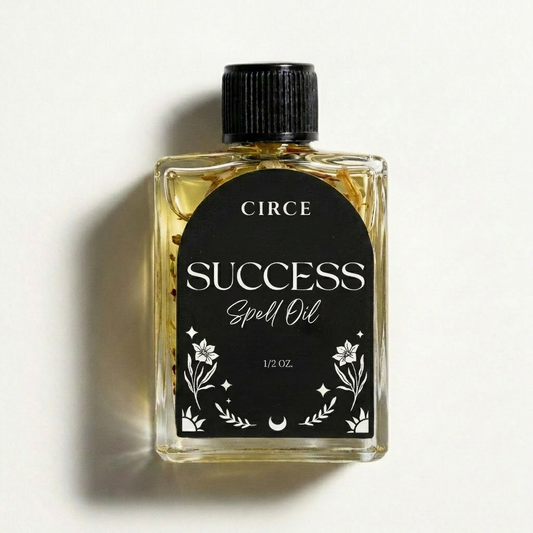Success ritual oil in a small twist-top glass bottle with ginger root