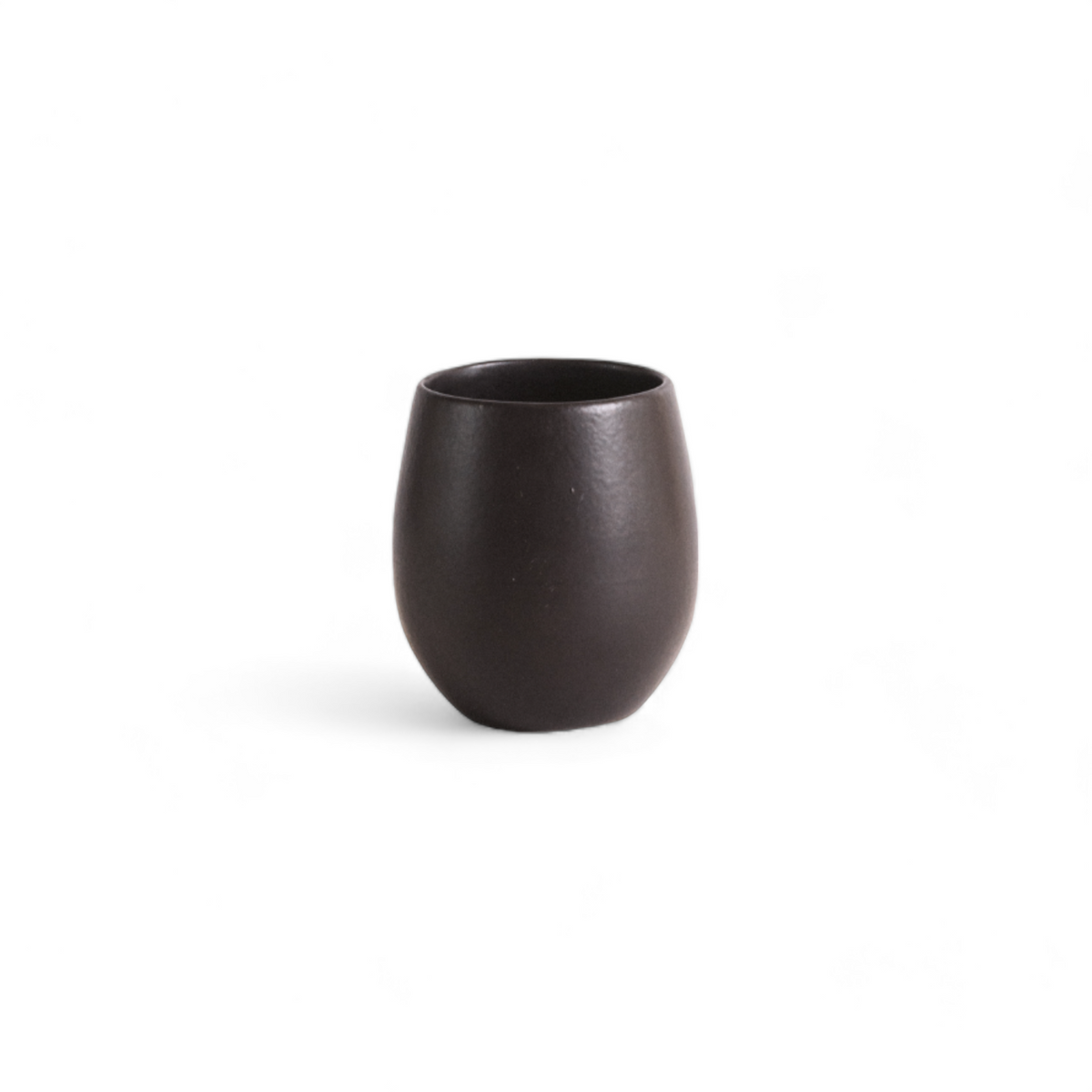 Black Epa stoneware cup, matte and handleless, on a pale background