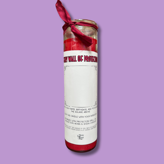 A tall red seven-day glass jar candle with a Fiery Wall of Protection label.