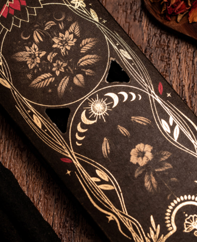 Gold floral and moth illustration on the Cacao Ritual box