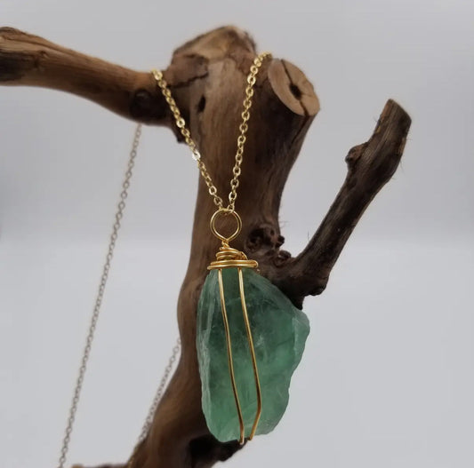 Green fluorite necklace with a raw sea-green crystal wrapped in gold-toned wire.