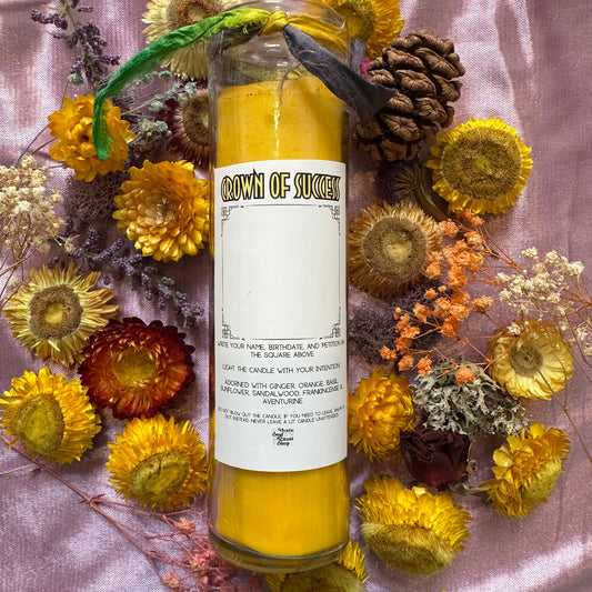 A tall yellow seven-day glass jar candle with a Crown of Success label.