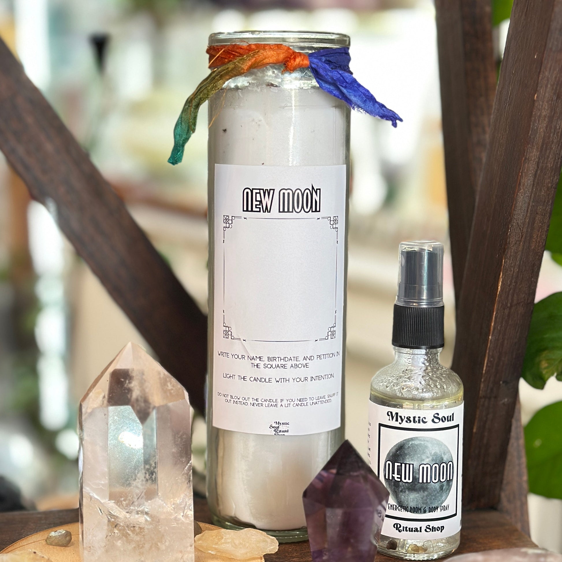 The New Moon seven-day candle showing rainbow moonstone set into the dressed wax.