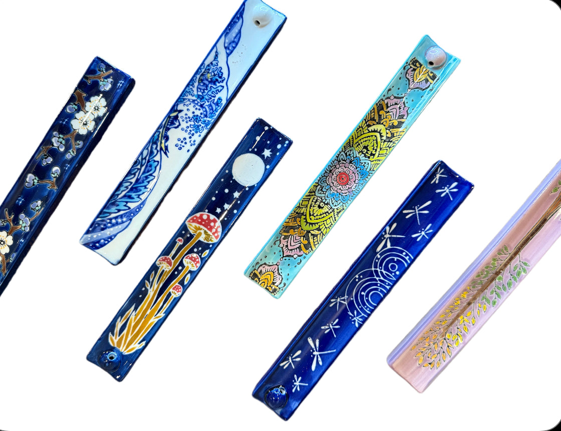 Group of blue and gold painted incense holder trays arranged at angles