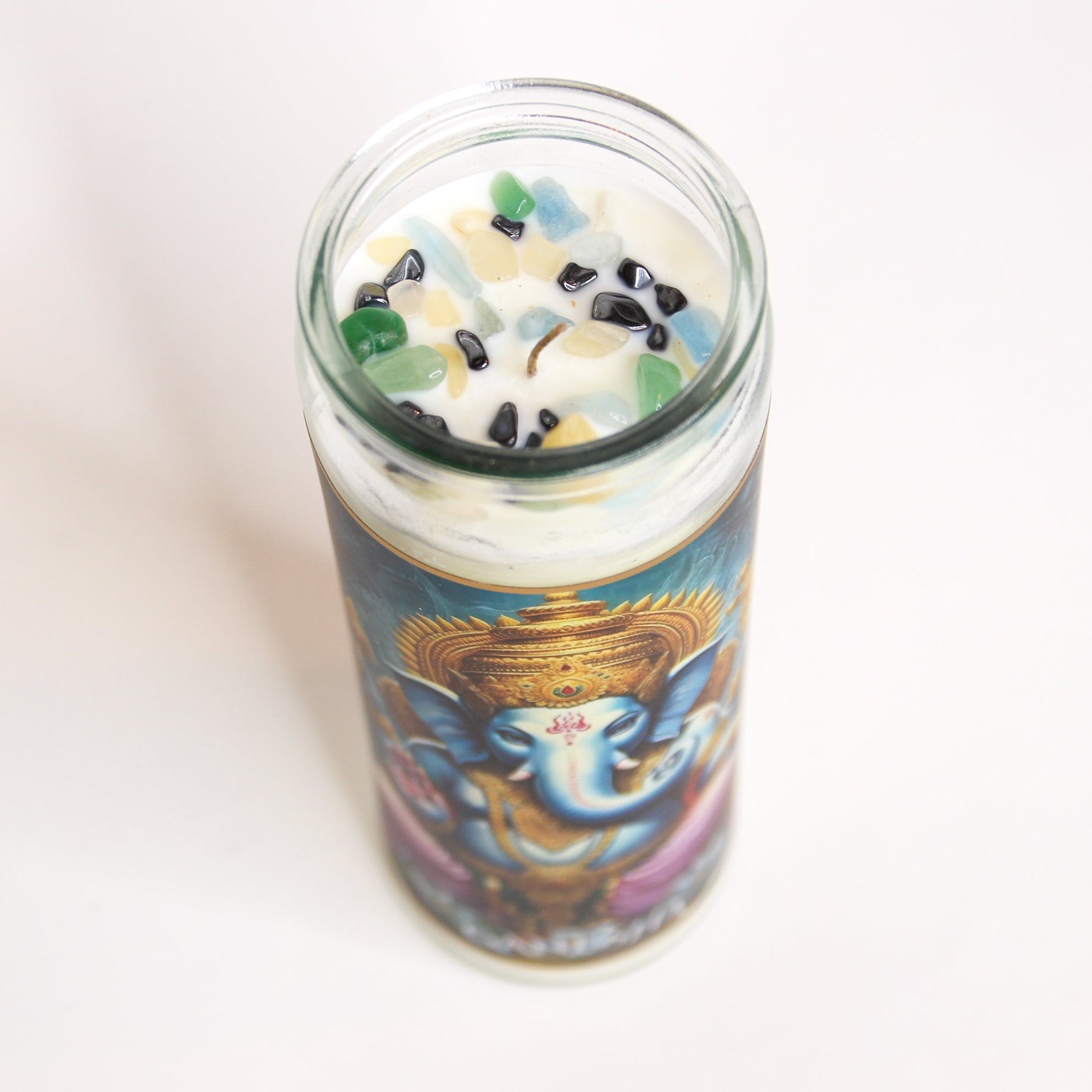 Ganesha Crystal Altar Candle in a 16 oz glass tumbler with an image of Ganesha on the label and crystals set into the wax — product photo 3