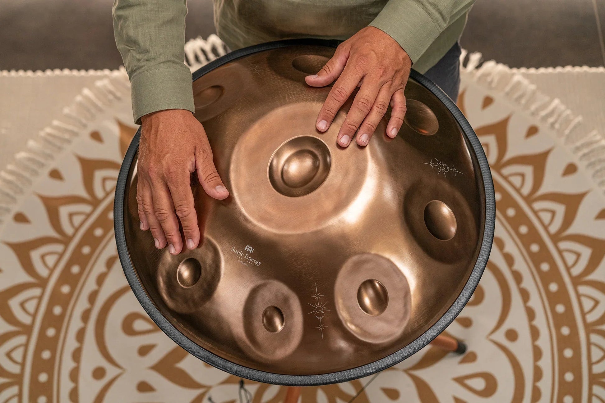 Vintage copper Sensory handpan with engraved design shown in a warm, styled ritual scene.