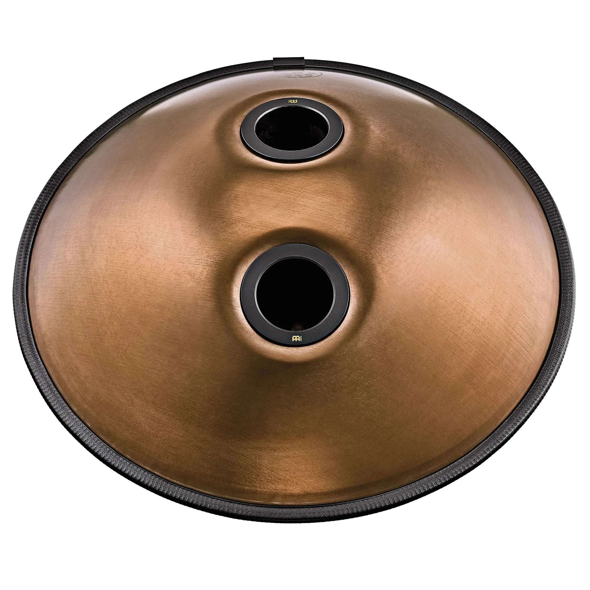 Vintage copper Sensory handpan with engraved design shown in a warm, styled tabletop arrangement.