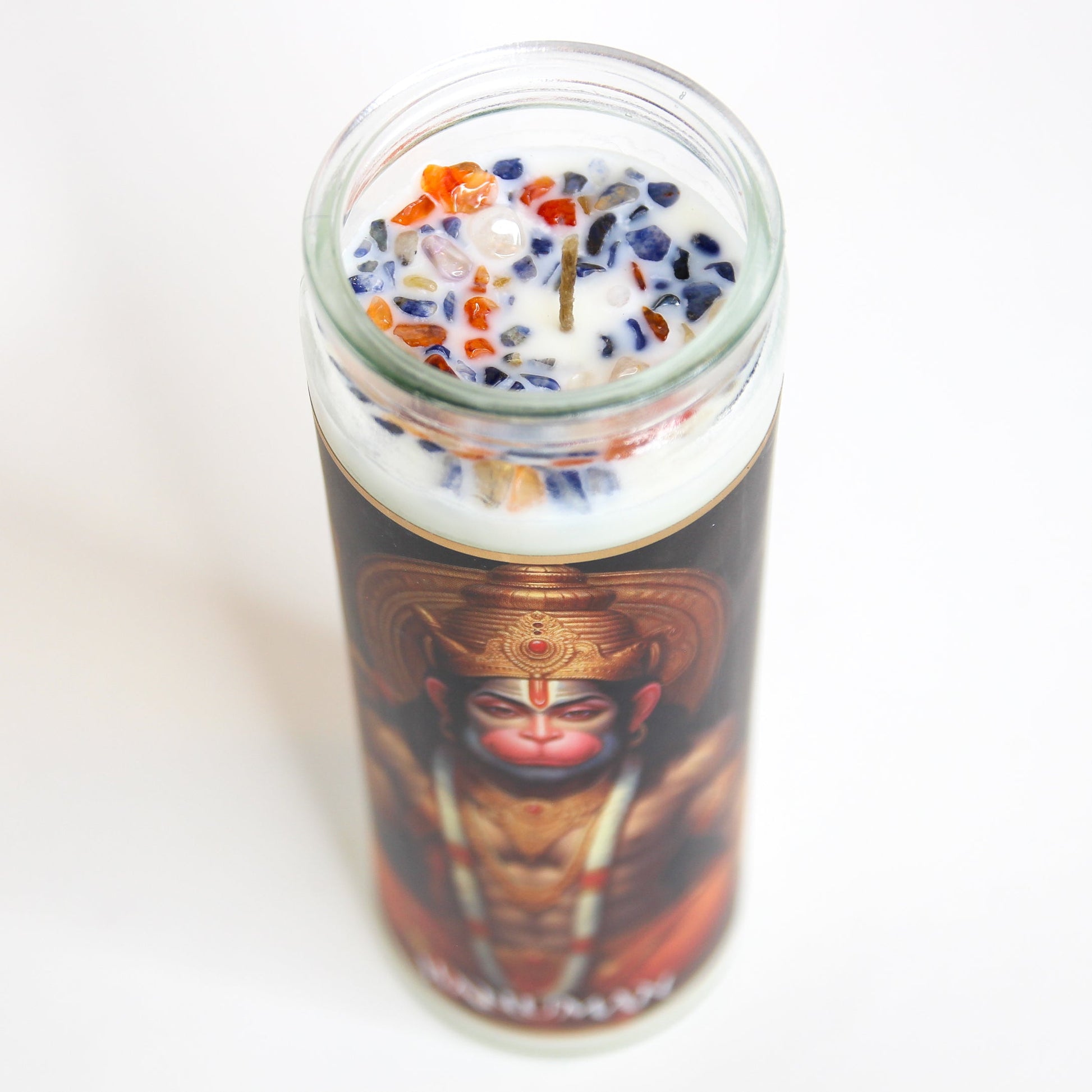 The Hanuman altar candle lit, showing the flame and melt pool