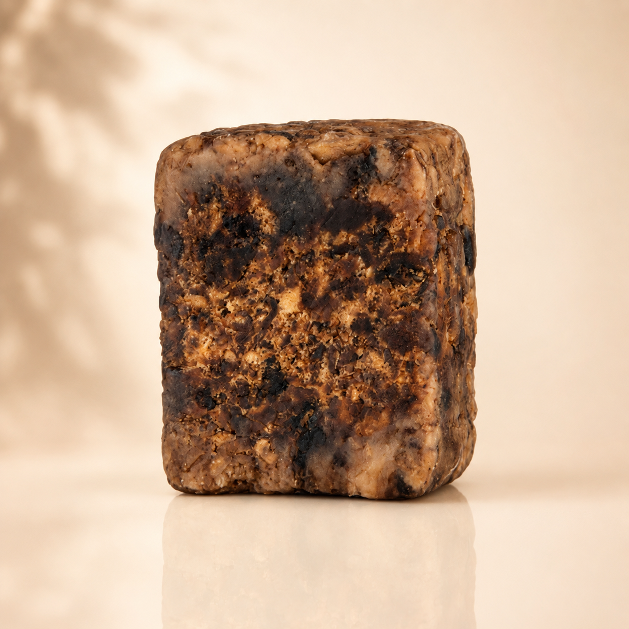 Raw African black soap bar with a rough, natural surface