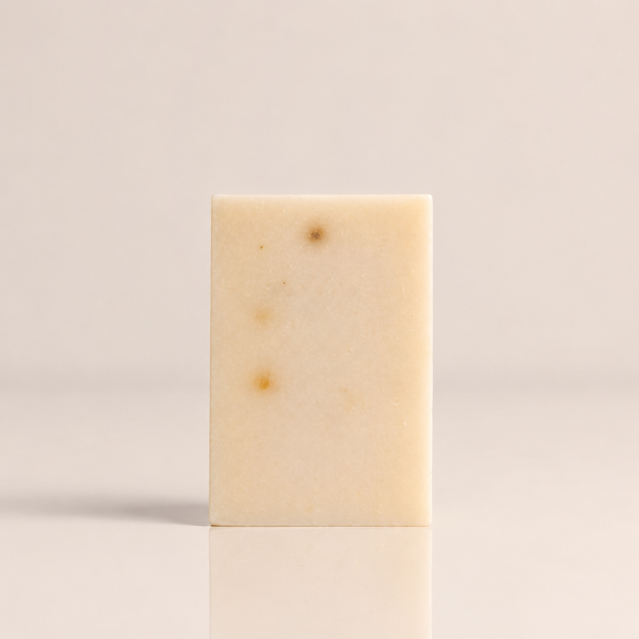 Grapefruit and tea tree clarifying bar soap with visible oatmeal and salt texture