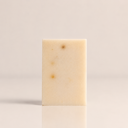 Grapefruit and tea tree clarifying bar soap with visible oatmeal and salt texture