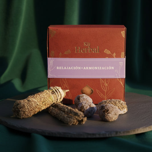 Terracotta Kit Herbal box with the relaxation and harmonization band on a dark slate plate, with a bound smudge stick, two herb sticks and four bombitas.