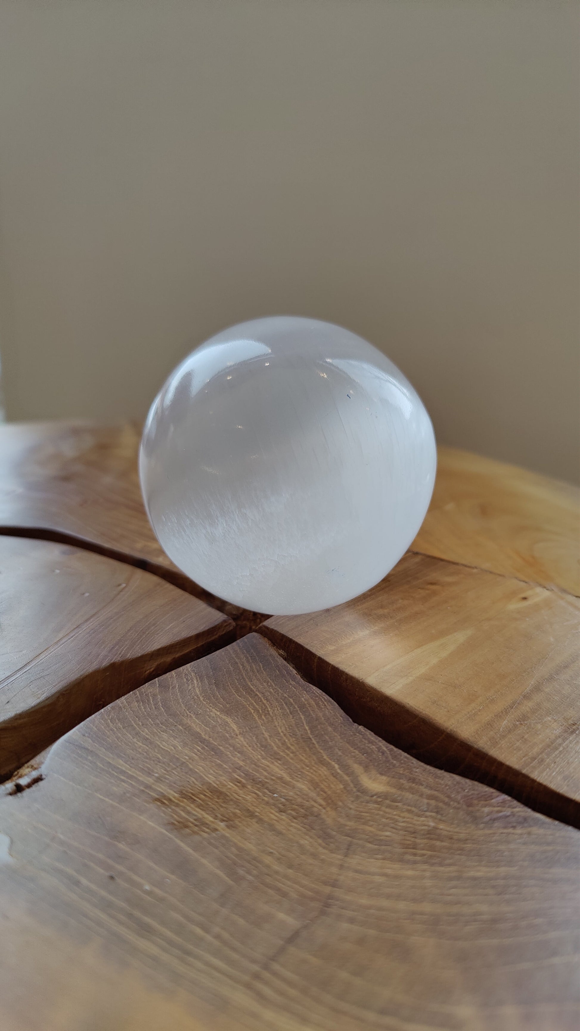 Selenite sphere showing the fibrous grain beneath the polished surface