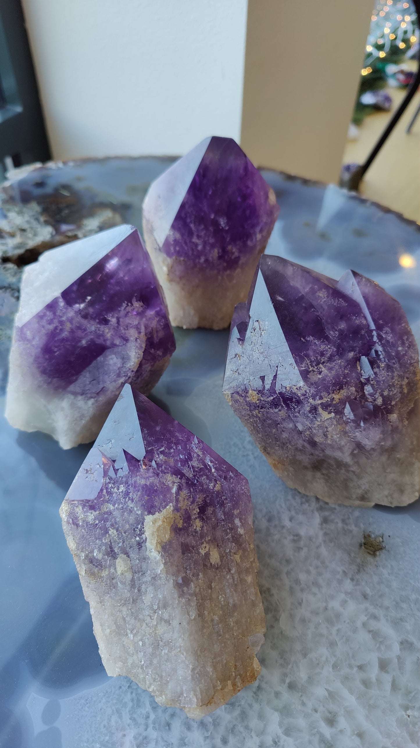 Large Bolivian amethyst point standing upright against a dark background
