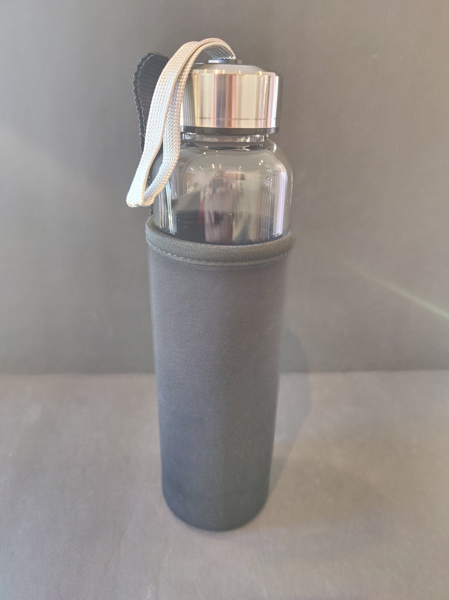 Sixteen-ounce crystal infused water bottle in stainless steel and glass with a fabric insulation sleeve and a crystal chamber in the base — view 2