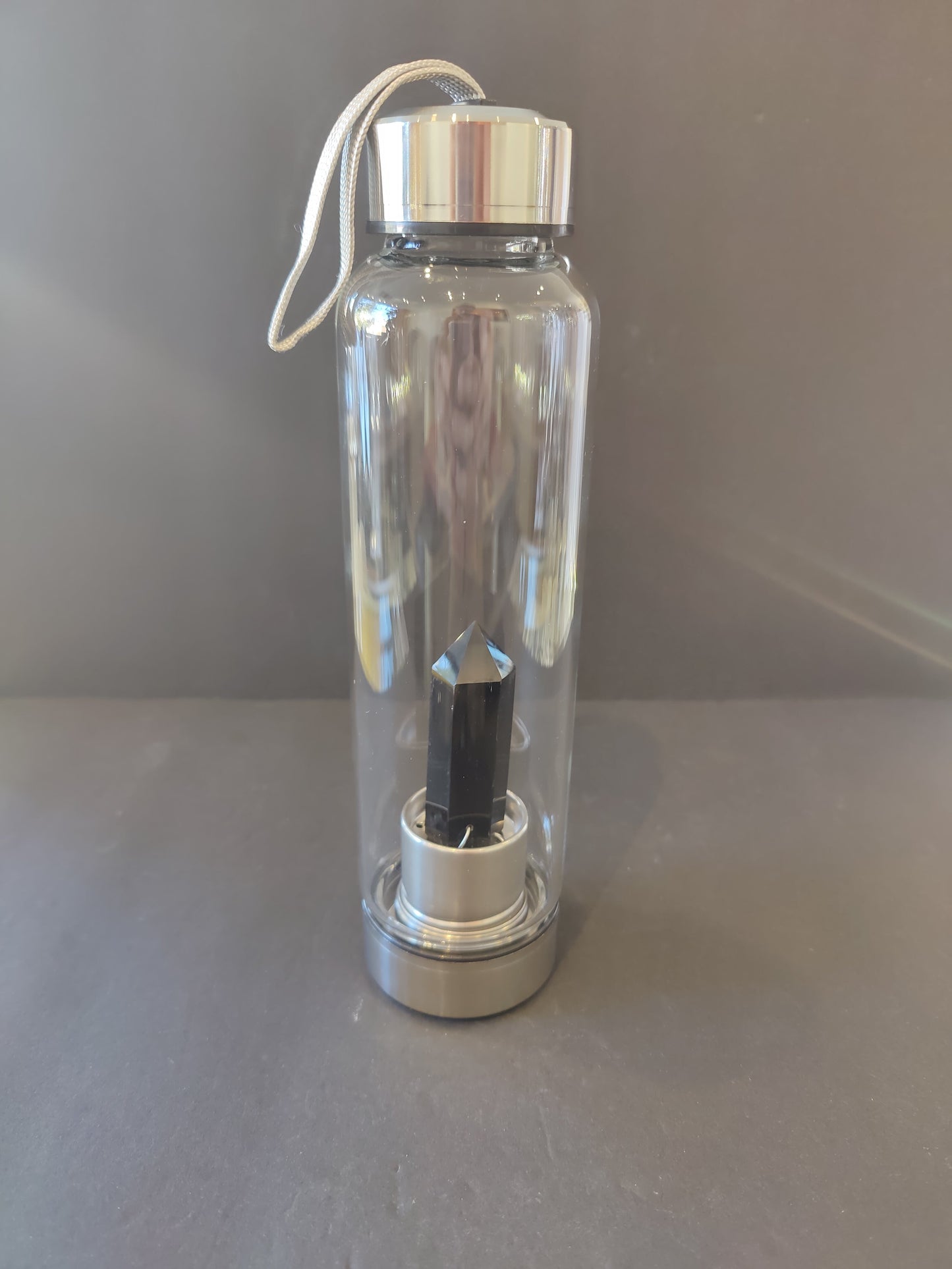 Sixteen-ounce crystal infused water bottle in stainless steel and glass with a fabric insulation sleeve and a crystal chamber in the base — view 6