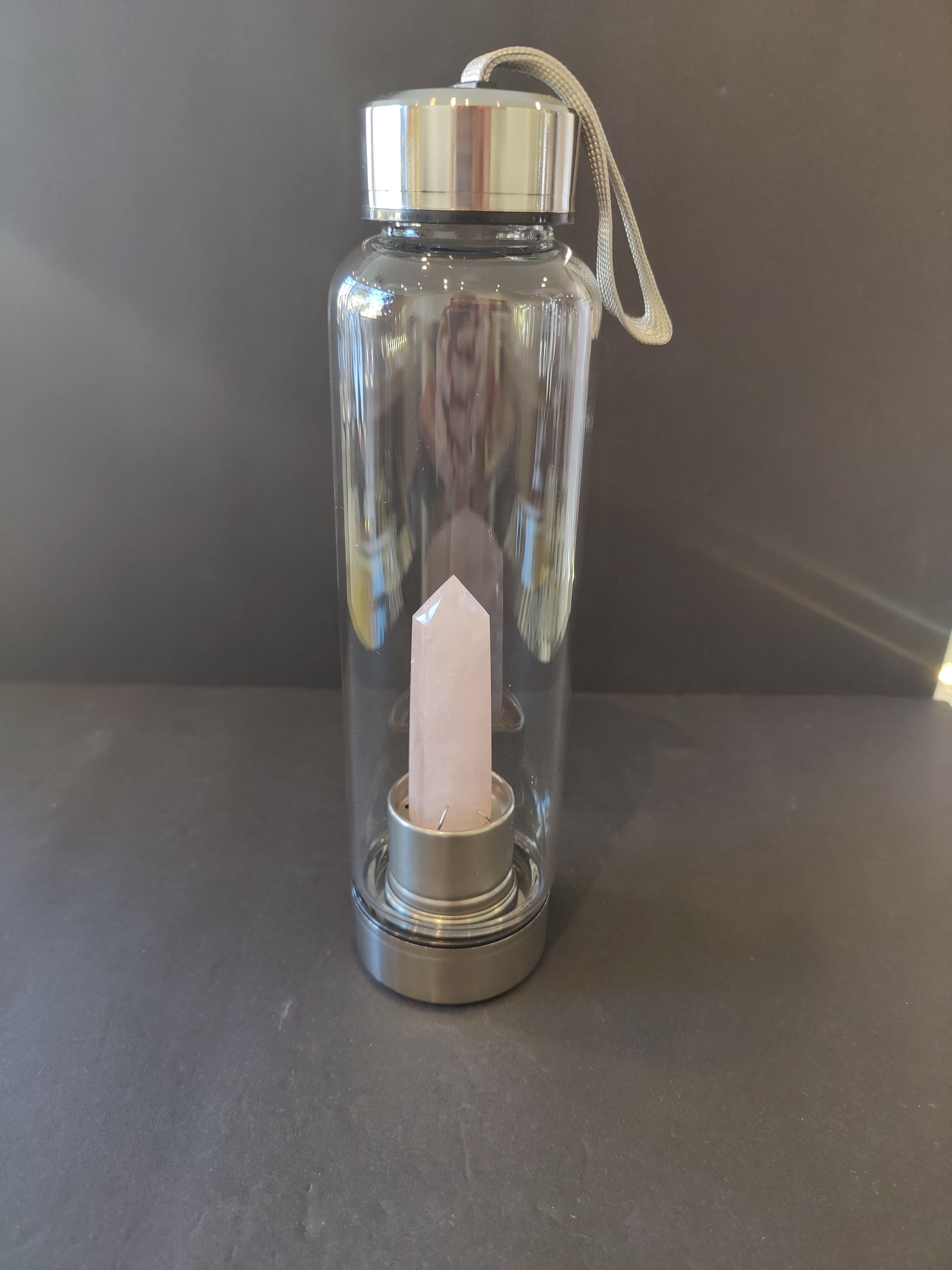 Sixteen-ounce crystal infused water bottle in stainless steel and glass with a fabric insulation sleeve and a crystal chamber in the base — view 5