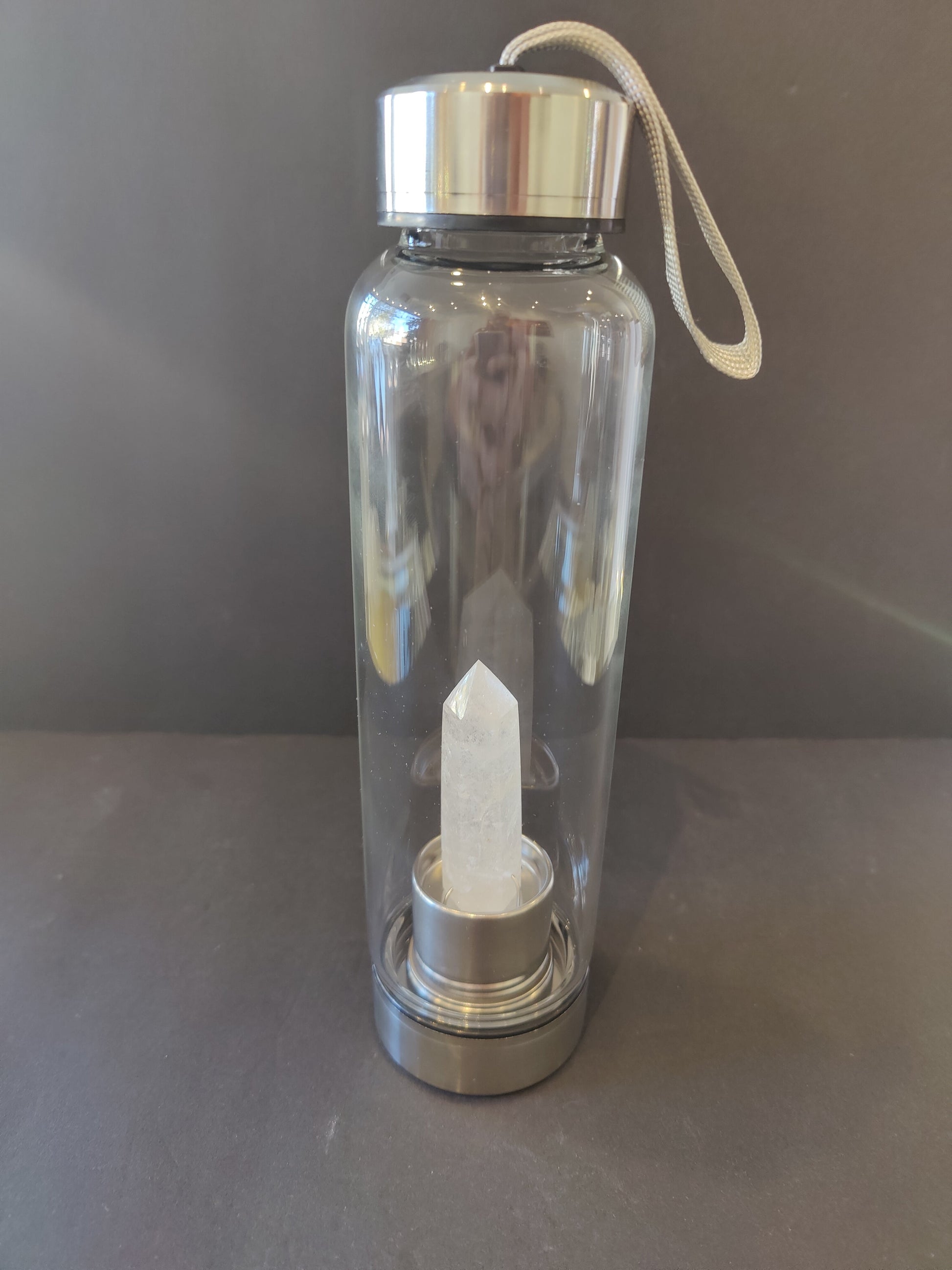 Sixteen-ounce crystal infused water bottle in stainless steel and glass with a fabric insulation sleeve and a crystal chamber in the base — view 4