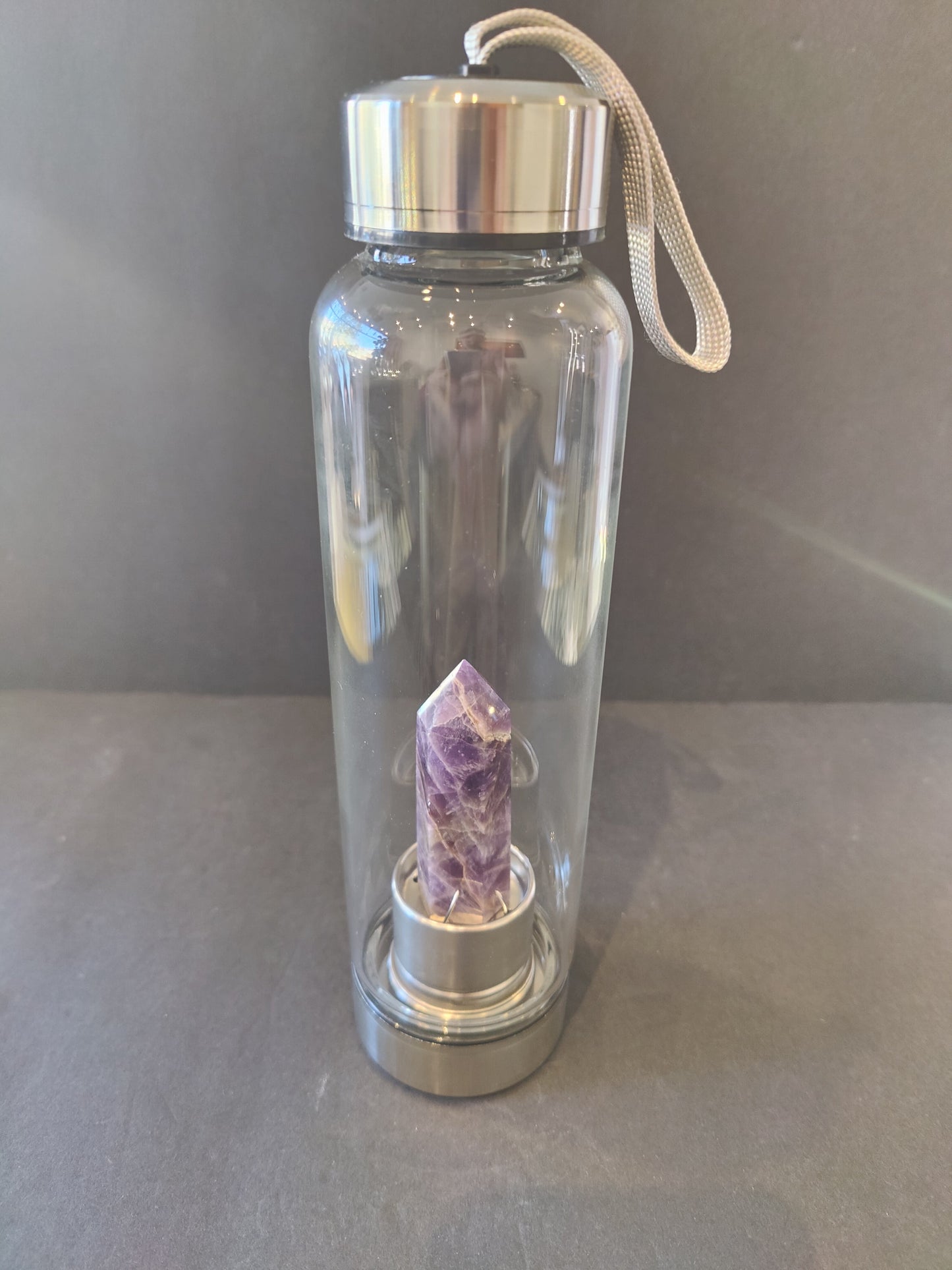 Sixteen-ounce crystal infused water bottle in stainless steel and glass with a fabric insulation sleeve and a crystal chamber in the base — view 3