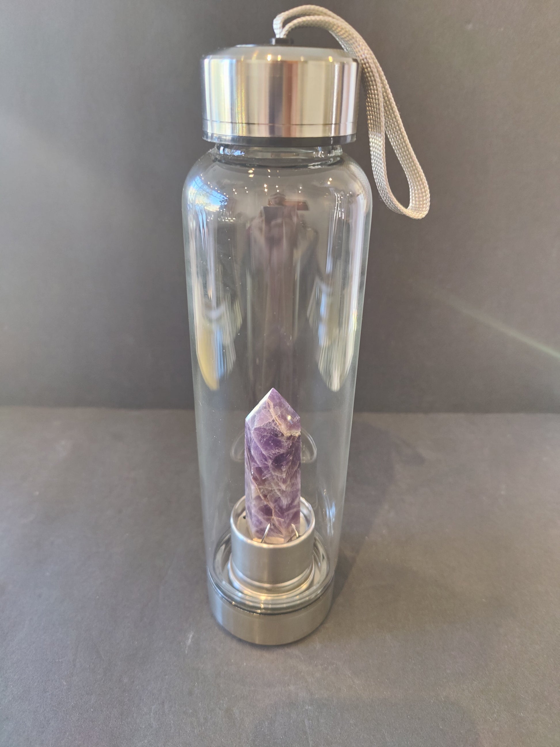 Sixteen-ounce crystal infused water bottle in stainless steel and glass with a fabric insulation sleeve and a crystal chamber in the base — view 3