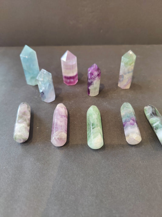 Polished multi-colour fluorite point with green, purple and clear banding