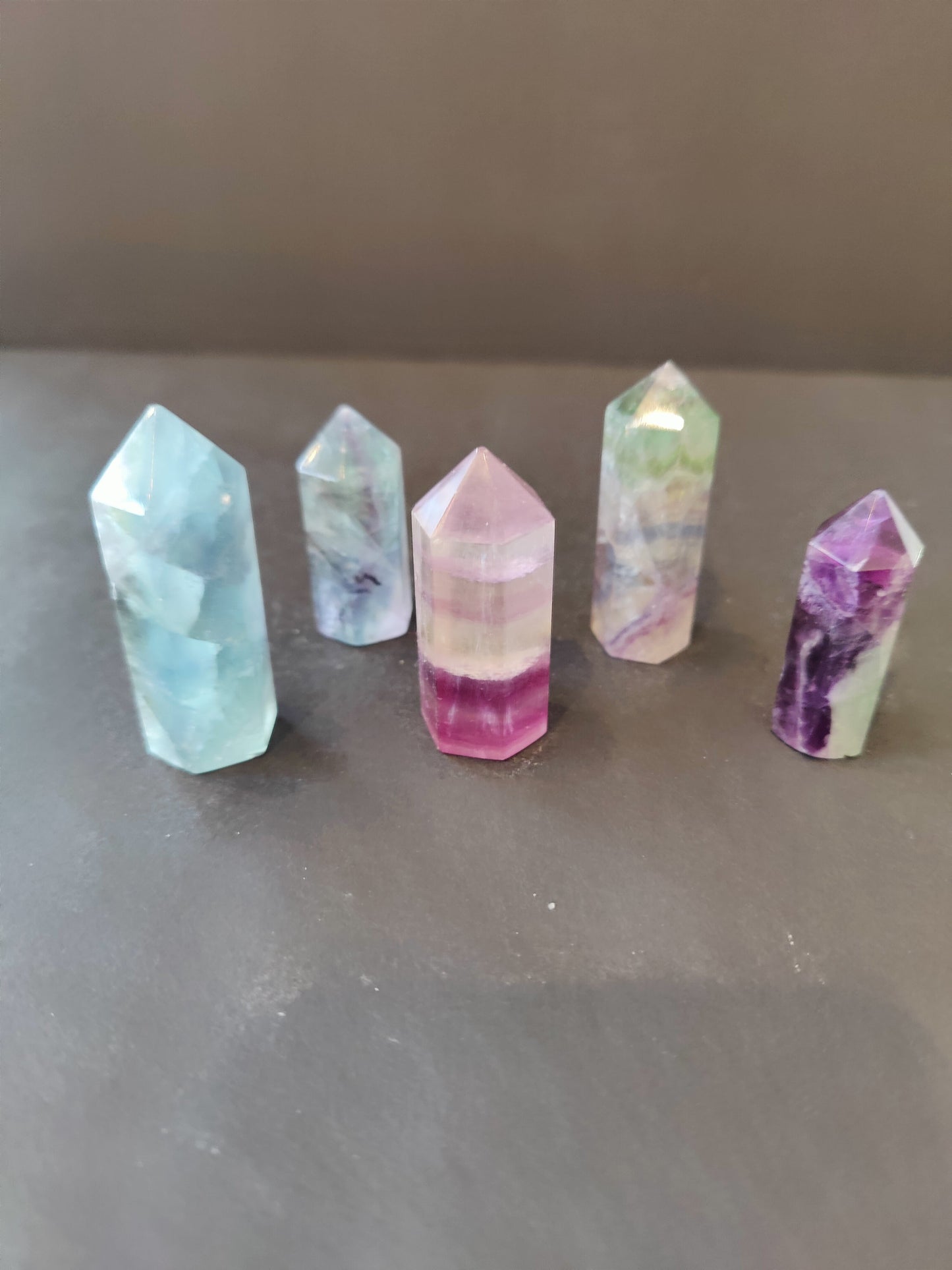 Polished multi-colour fluorite point with green, purple and clear banding — view 2