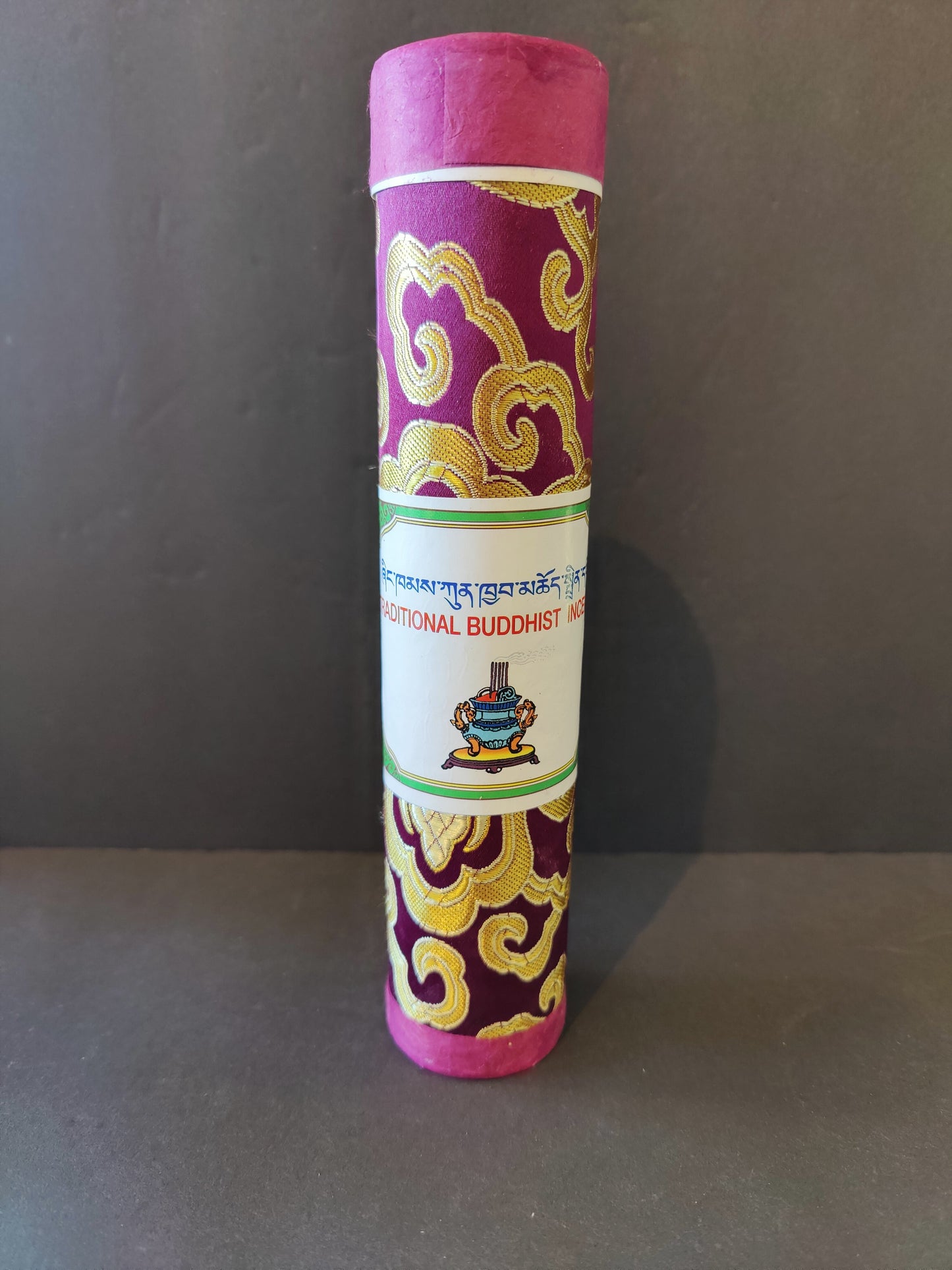 Bundle of hand-rolled Tibetan incense sticks from Nepal tied with cord, on a dark surface — view 2