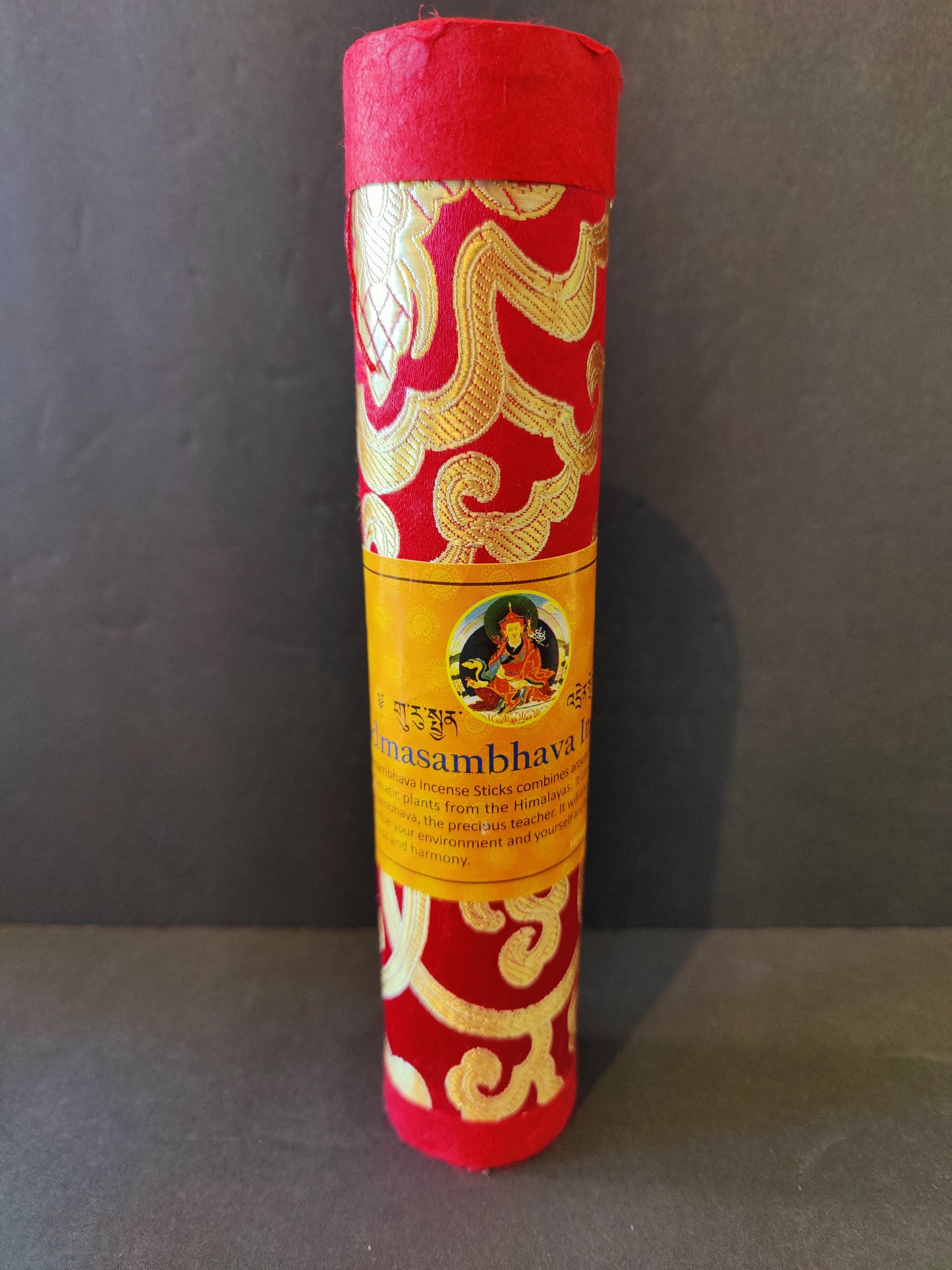 Bundle of hand-rolled Tibetan incense sticks from Nepal tied with cord, on a dark surface — view 3