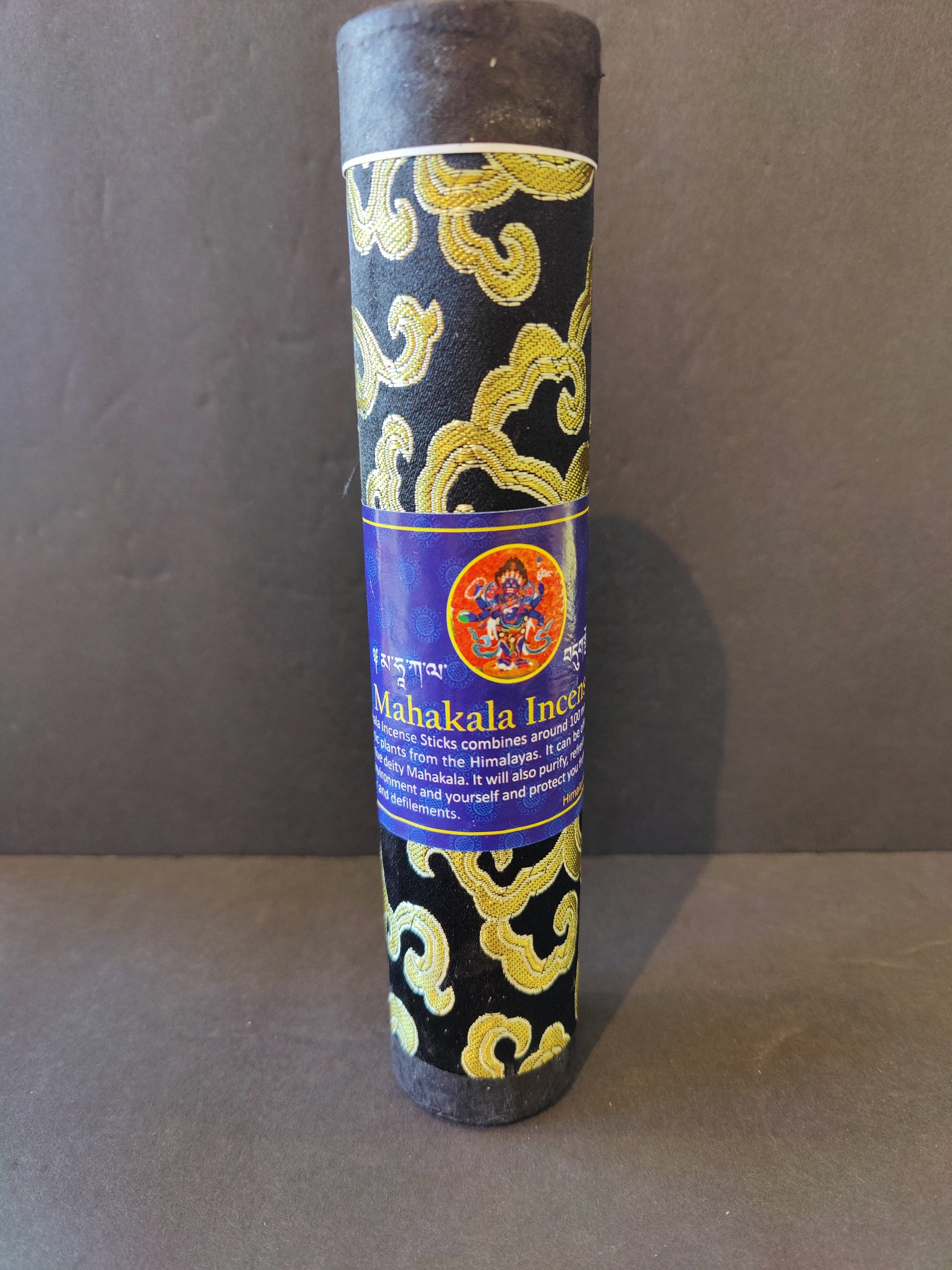 Bundle of hand-rolled Tibetan incense sticks from Nepal tied with cord, on a dark surface — view 4