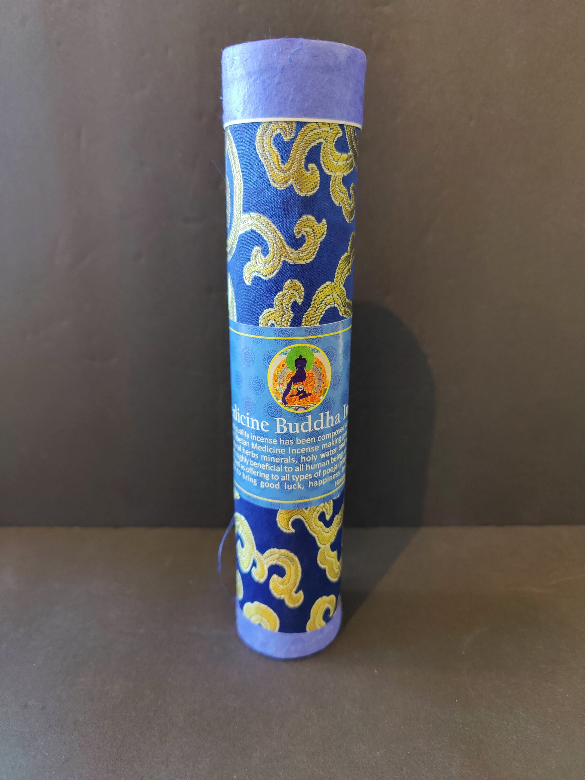 Bundle of hand-rolled Tibetan incense sticks from Nepal tied with cord, on a dark surface — view 5