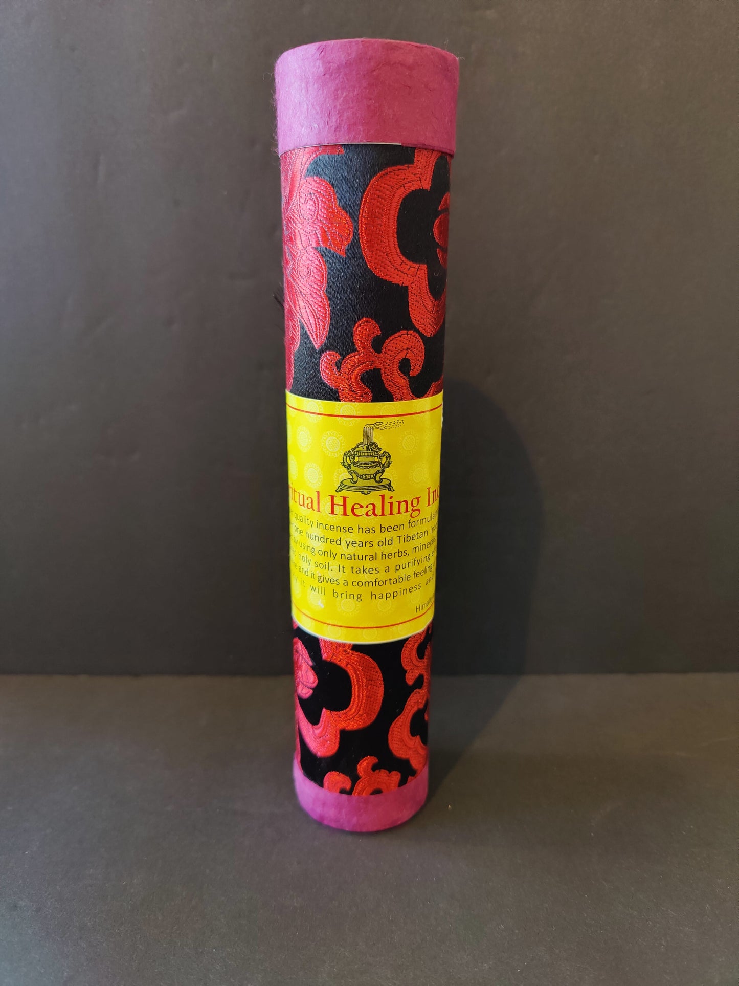 Bundle of hand-rolled Tibetan incense sticks from Nepal tied with cord, on a dark surface — view 8