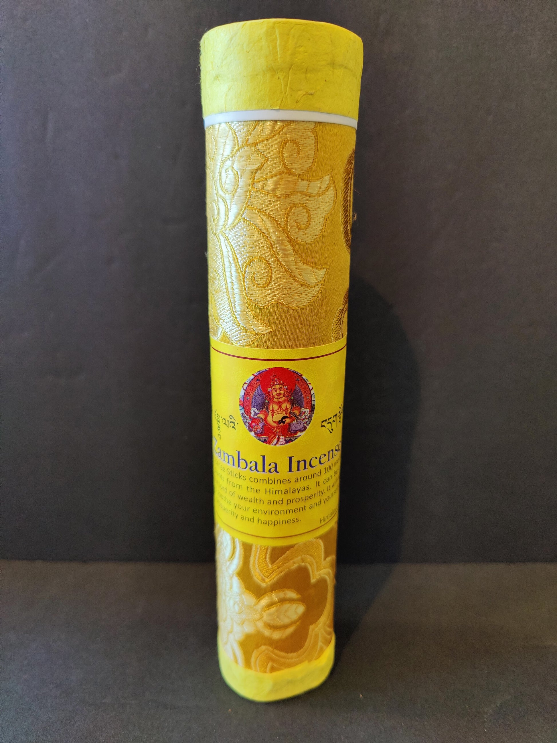 Bundle of hand-rolled Tibetan incense sticks from Nepal tied with cord, on a dark surface — view 10