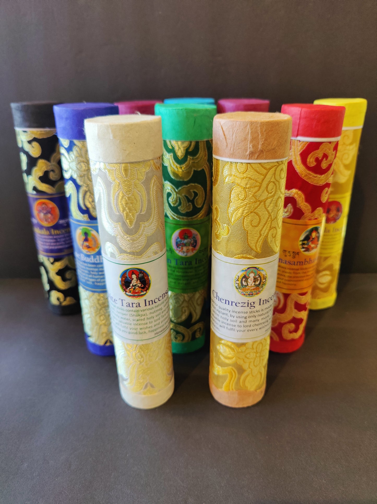 Bundle of hand-rolled Tibetan incense sticks from Nepal tied with cord, on a dark surface