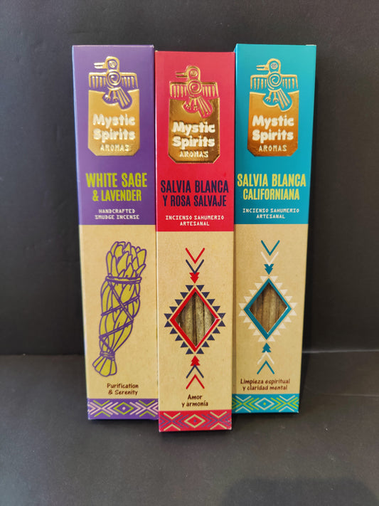 Pack of white sage smudge incense sticks fanned out on a dark surface