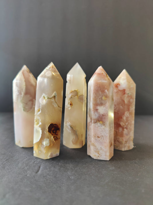 Polished flower agate tower in soft pink with white blossom-like plumes through the stone